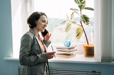 Legal Business Consultant, Legal Advisor, female lawyer confident young businesswoman talking on cell phone in modern office