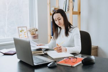 Remote Accounting Finance Jobs. Online Accounting Solution. Candid portrait of female accountant working with laptop, calculator and documents at home office.